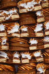 Delicious cookies close-up. Chocolate and caramel sweets with custard curls