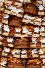Delicious treats close-up. Chocolate and caramel sweets with cookies and custard