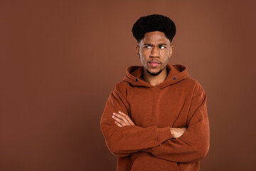 Photo of dislike brunet hairdo young guy crossed arms look empty space dress sportswear isolated on...