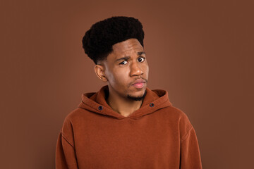 Photo of unsure brunet hairdo young guy look camera dress sportswear isolated on brown color background