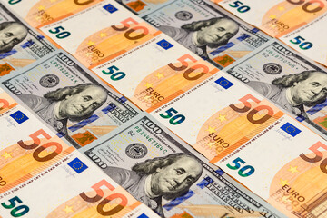 Dollars and euros, confrontation and domination, influence, world currencies close up.