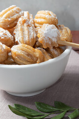 Tasting churros of dulce de leche in a bowl.