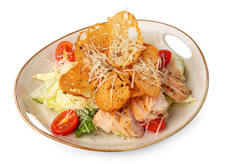 Caesar salad with grilled chicken on white wooden background