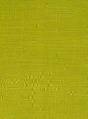 Green grass color fabric background with a small round rib. Cotton fabric with a simple pattern