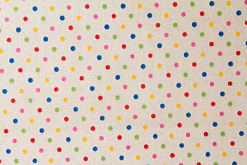 White fabric with multicolored small polka dots.Fabric background and texture for design