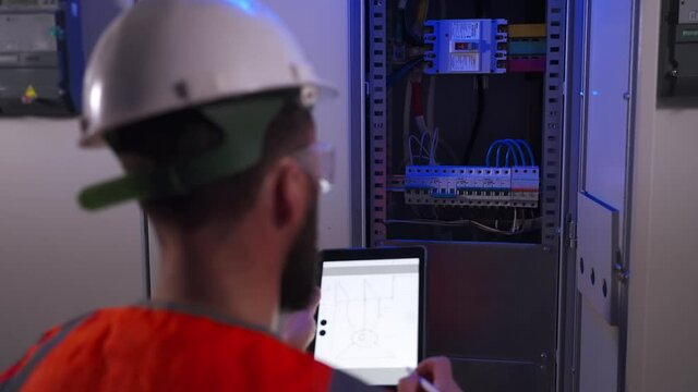 electrical engineer is drawing electrical panel diagram by tablet
