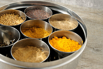 Masala Dabba Indian typical spice box. Spices assortment in round tin.