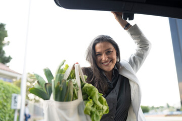 woman in car trunk with purchase