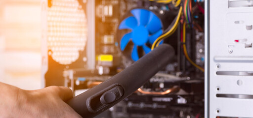 Cleaning the system unit of a desktop computer from dust with a vacuum cleaner