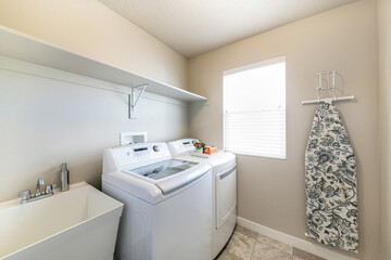 Simple laundry room interior with washing machines