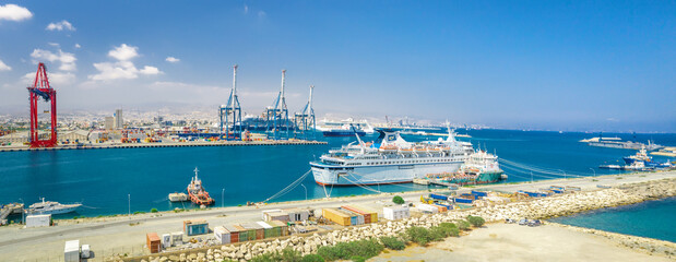 Panorama of Limassol sea port (Cyprus) with docked cruise and freight ships, and cargo shipping...