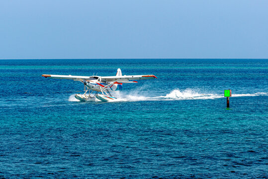 Seaplane landing in the boat channel bringing guests to a remote island for a day of beach recreation.