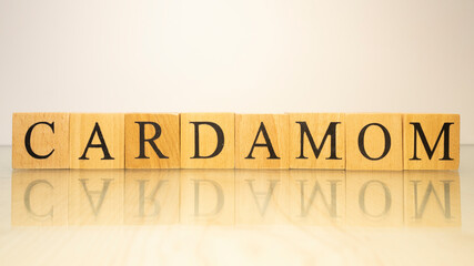 The word Cardamom was created from wooden letter cubes. Gastronomy and spices.