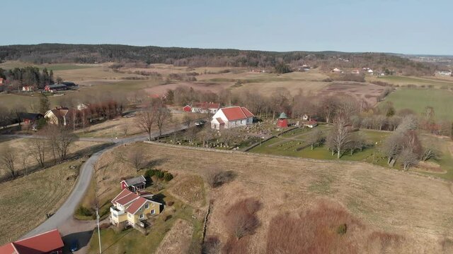 A 4K footage of the Bergum's church near an agricultural field in Sweden