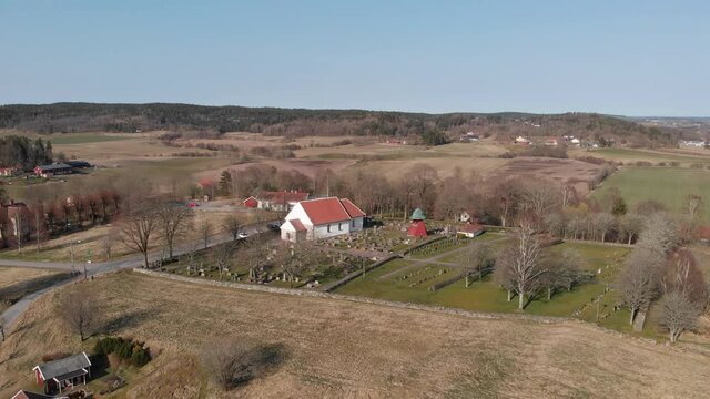 A 4K footage of the Bergum's church near an agricultural field in Sweden