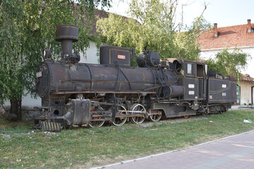 Old black steam locomotive on old rails