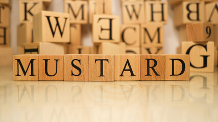 The word Mustard was created from wooden letter cubes. Gastronomy and spices.