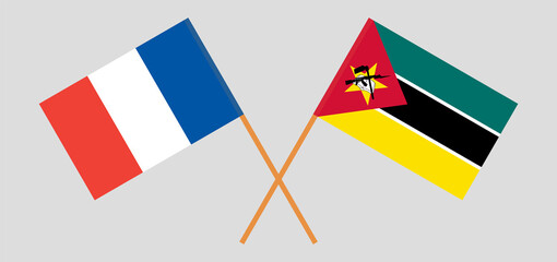 Crossed flags of France and Mozambique. Official colors. Correct proportion