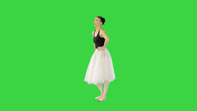 Young ballerina in tutu warming up on a Green Screen, Chroma Key.