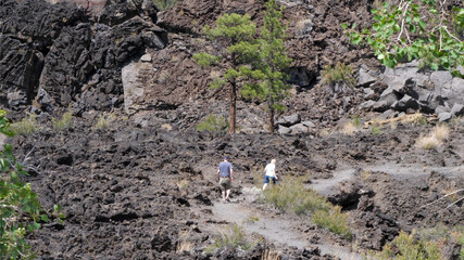 tourists hike into lava flow
