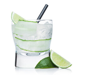 Gimlet cocktail in modern glass with ice cubes and straw, cucumber and lime slice on white.