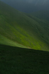 Fototapeta premium Sun light on the mountain green hill creating contrast area