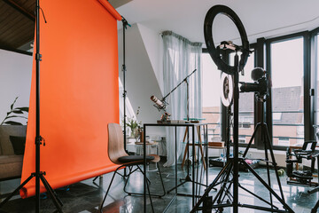 Backdrop with ring light and photographic equipment at home workshop