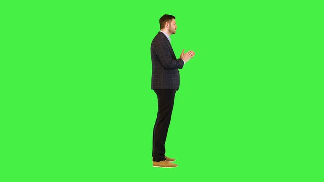 Excited businessman speak actively gesticulate Business man in formal wear get cheerful happy talk on a Green Screen, Chroma Key.