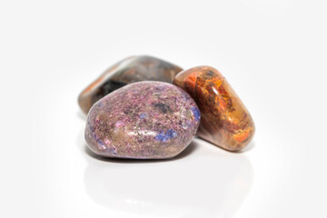 Close up shot of polished colorful rocks on white background