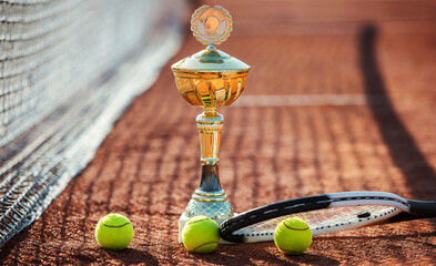 Tennis balls with a racket and cup on the tennis court. Sport, recreation concept