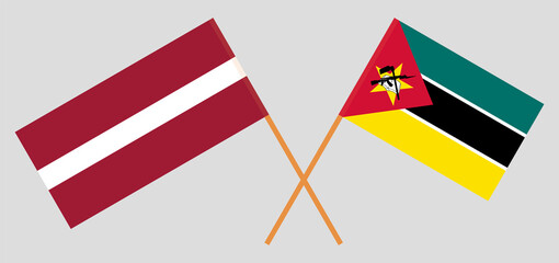 Crossed flags of Latvia and Mozambique. Official colors. Correct proportion