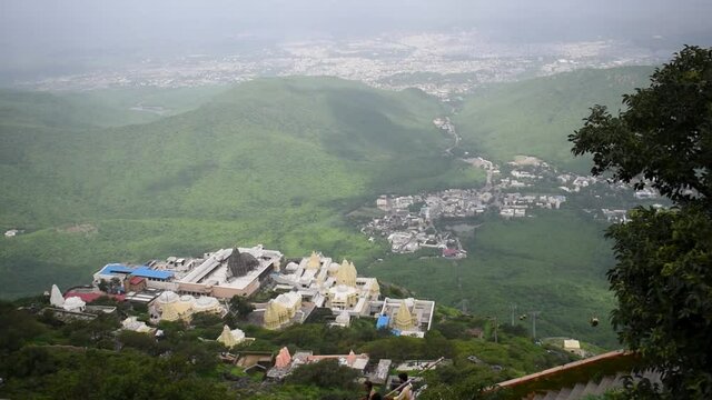 View of Jain Temples in Junagadh with city from Girnar mountain in foggy morning. View from half way to the top of Girnar Hill. Gujarat, India