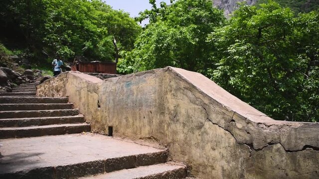Girnar mountain view from the stairs. Stairs covered with trees on both side. Concept of trekking in mountains