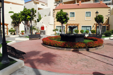 Fountain & Trees in Sunny Courtyard of Spanish Holiday Village 