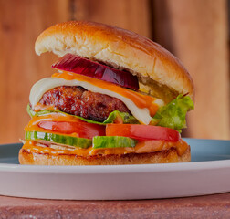 Turkey burger on a plate,with wooden background.