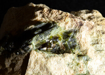 Blotting of green actinolite mineral crystals in rock from Ural, Russia. For geology websites, stone collection catalog, Natural Science museum wall chart.