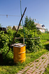 yellow garden barrel for collecting rainwater in the garden