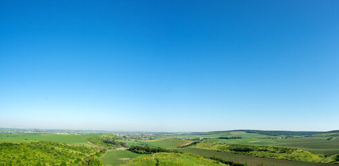 Panorama of meadows, fields and the small town of Rohatyn on a sunny day in summer in Ukraine
