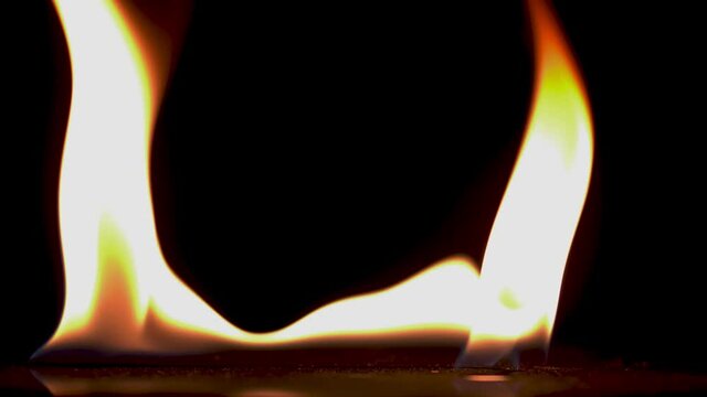 B roll of Close-up of flames burning slow motion background footage. Flames fire on black background. Burning fire. Bonfire. 