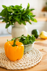 Close-up shot of the ingredients for a healthy summer salad with pepper, microgreen. There is spinach in the background