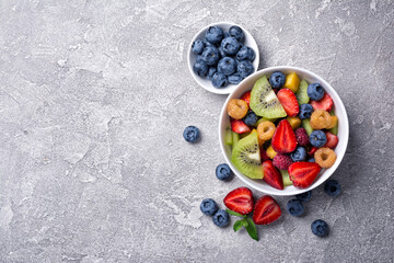 Bowl of healthy salad with fresh fruits and berries