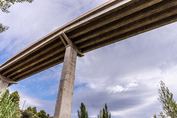 View from below to a modern concrete bridge.