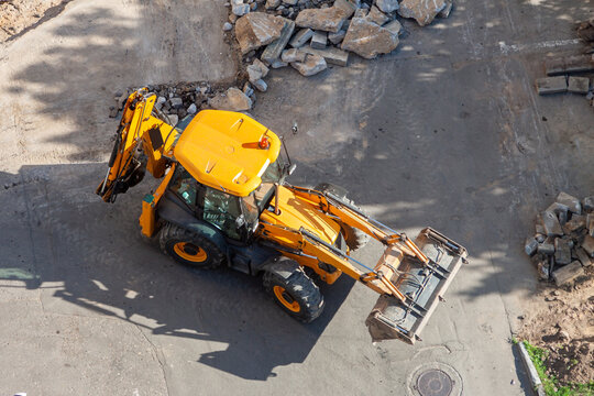Aerial view yellow wheel loader excavator construction site with rubble road