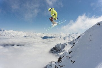 Naklejka na ściany i meble Skier jumps in the mountains. Mountain ski, winter extreme sport.