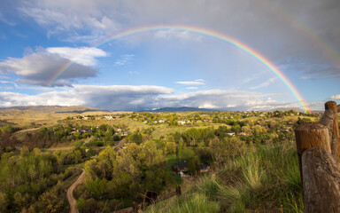 Boise Idaho neighborhood skyline with rainbow after rain during Summer. View from Camels Back Park.