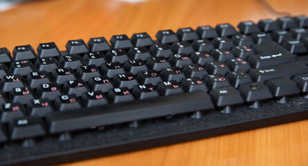 A case-free black keyboard on the table.