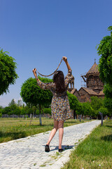 A girls scarf is playing with the wind