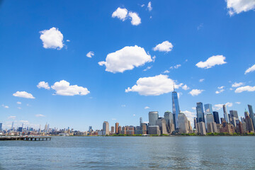 Unique shape clouds float over the Lower Manhattan skyscraper in springtime at New York City NY USA on May 14 2021. Image was taken from Jersey City NJ.