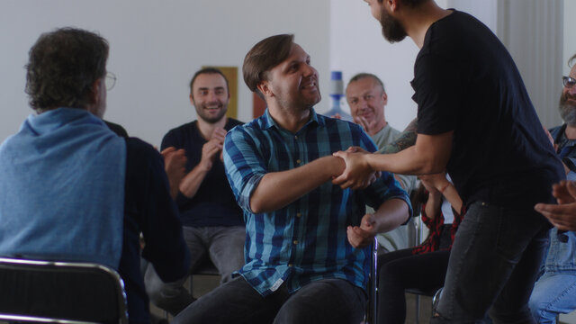 People applauding to reformed addict during AA meeting