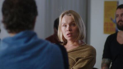 Woman talking about mental disorder with group